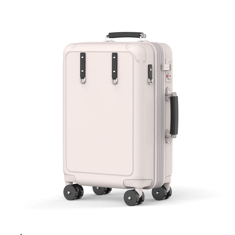 Pale pink Origin Standard carry-on with dark handles and wheels